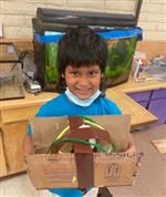 student smiling with completed maze 